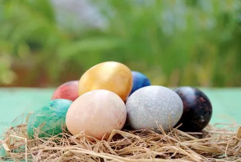 Easter basket with easter eggs on wooden background Stock Photos