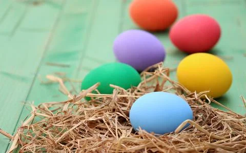 Easter basket with easter eggs on wooden background Stock Photos