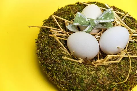 Easter basket with easter eggs on Yellow background Stock Photos