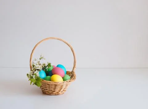 Easter basket with eggs on a white background. Beautiful Easter composition w Stock Photos