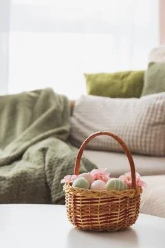 Easter Basket with Ester Eggs,  Plush Bunny and Spring Decor on White Table.. Stock Photos