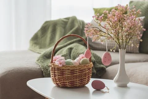 Easter Basket with Ester Eggs,  Plush Bunny and Spring Decor on White Table.. Stock Photos