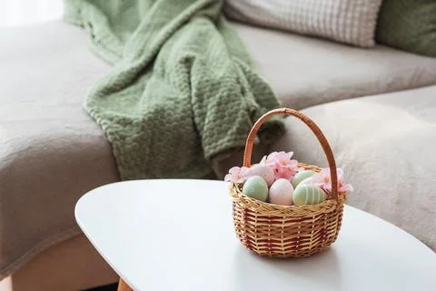 Easter Basket with Ester Eggs,  Plush Bunny and Spring Decor on White Table.. Stock Photos