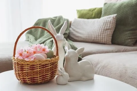 Easter Basket with Ester Eggs,  Plush Bunny and Spring Decor on White Table.. Stock Photos