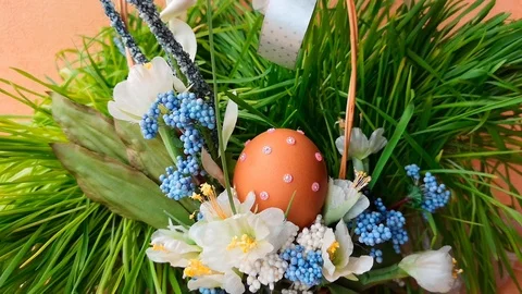 Easter basket with flowers and Easter egg decorated with rhinestones Stock Footage 104589663
