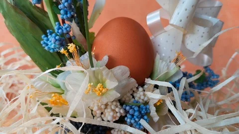Easter basket with flowers and egg among straw Stock Footage 104589587