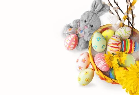 Easter basket with flowers, eggs and cute bunny on a isolated white background Stock Photos