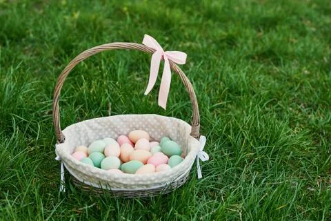 Easter basket on spring green grass. Cute egg . Easter egg hunt. Happy Easter Stock Photos