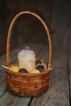 Easter basket on a wooden background. Photos