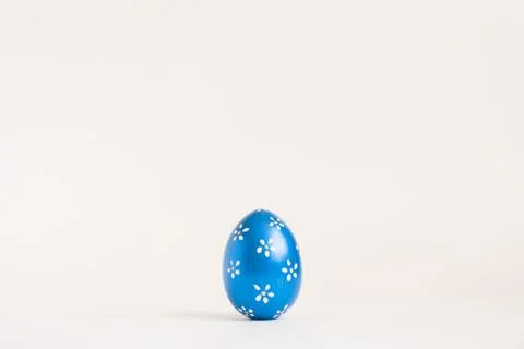 Easter blue egg with with floral pattern isolated on white background. Minimal Stock Photos