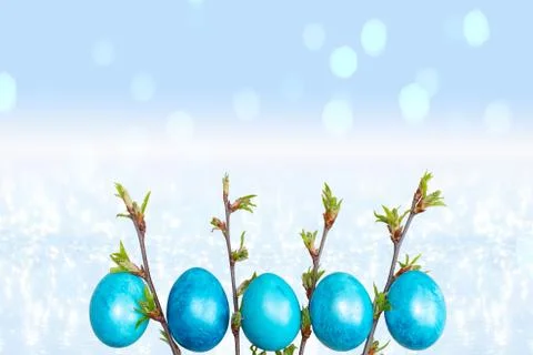 Easter blue eggs on a light blue sparkling background with bokeh Stock Photos