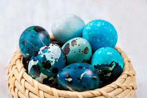 Easter blue quail eggs in a wicker basket Stock Photos