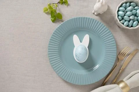 Easter blue table setting with bunny egg holder Stock Photos