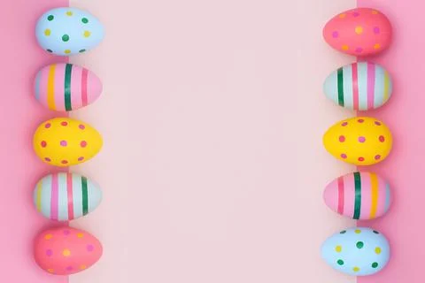 Easter border of vivid Easter eggs on a pink background. Stock Photos