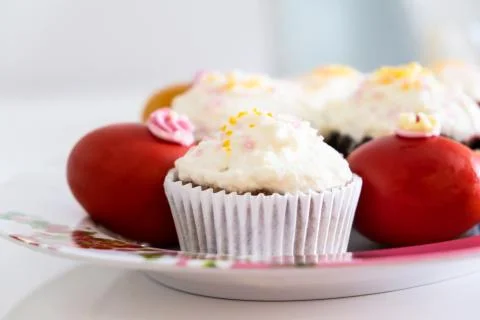 Easter bread cake and painted red eggs on a plate. Stock Photos