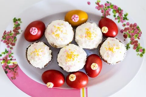 Easter bread cake and painted red eggs on a plate. Stock Photos