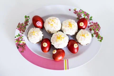 Easter bread cake and painted red eggs on a plate. Stock Photos