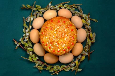 Easter bread in a circle of Easter eggs and a willow branch, a texture Stock Photos