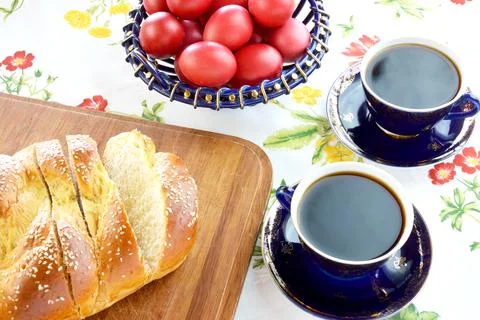 Easter bread, cups of coffee and  red eggs Stock Photos
