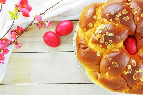 Easter bread, Easter eggs and a branch of flowering quince Stock Photos