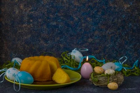 Easter bread on green plate and painted Easter eggs Stock Photos