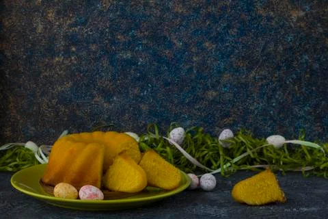 Easter bread on green plate and painted Easter eggs Stock Photos