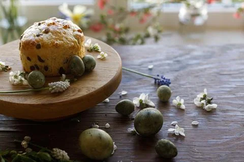 Easter bread, natural dyed eggs and spring flowers on rustic wooden table Stock Photos