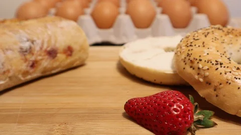 Easter Breakfast Farm Fresh Eggs, Bagel, Hot Cross Buns and Fruit 動画素材 128648203