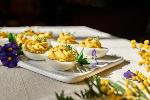 Easter breakfast idea. Stuffed easter eggs mimosa with egg yolk, turmeric, .. Stock Photos