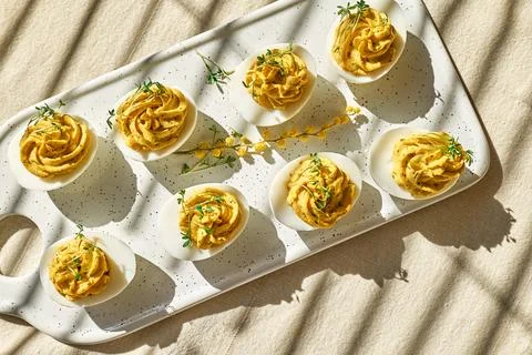 Easter breakfast idea. Stuffed easter eggs mimosa with egg yolk, turmeric, .. Stock Photos