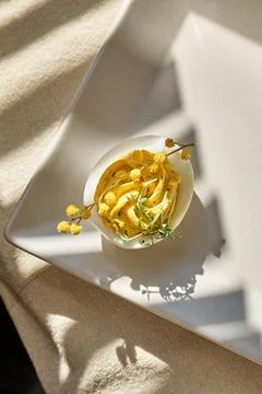 Easter breakfast idea. Stuffed easter eggs mimosa with egg yolk, turmeric, .. Stock Photos