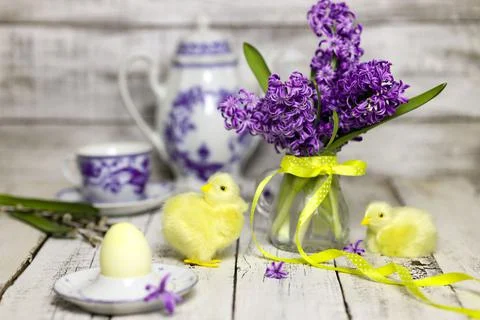 Easter breakfast table with tea,eggs in egg cups, spring flowers in vase and Stock Photos