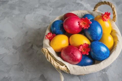 Easter bright colored eggs in the easter egg basket. Festive Easter multicolo Stock Photos