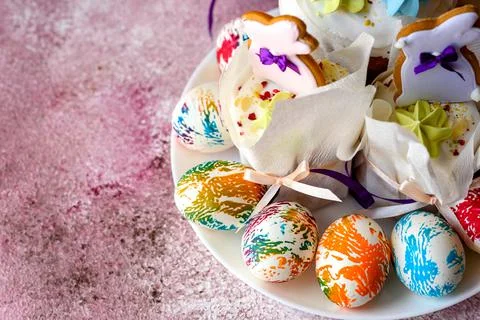 Easter bright multicolored eggs with Easter pies on a white ceramic plate on  Stock Photos