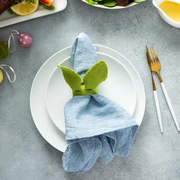 Easter brunch table setting with a napkin on a plate Stock Photos