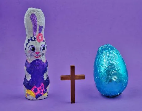 Easter Bunny and Easter Blue Egg on Purple Background Stock Photos