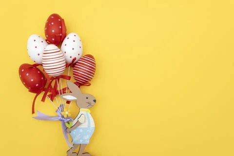 Easter bunny and Easter eggs on yellow background Stock Photos