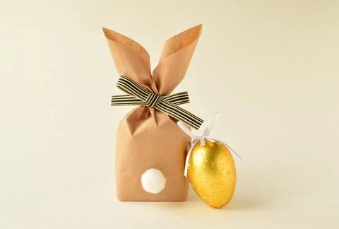 Easter bunny and egg on beige background Stock Photos