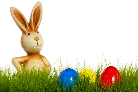 Easter bunny behind grass with easter eggs Stock Photos