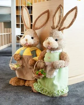 Easter bunny decorations holding baskets dressed spring clothing Stock Photos