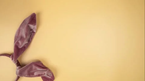Easter Bunny Ears on orange Background. moving from left to right Close Up. Pink Stock Footage 231474414