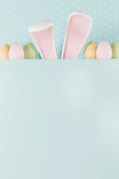 Easter bunny ears peek over colorful eggs on a pastel background Stock-Illustration