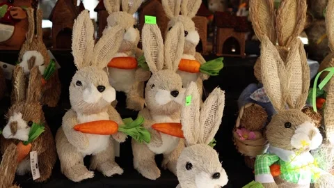 Easter bunny figurines with carrots rustic market display Stock Footage 331812171