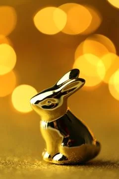 Easter bunny. Golden easter bunny on golden glitter background Stock Photos