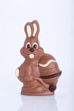Easter bunny made of chocolate with easter egg isolated on white background Stock Photos
