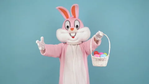 Easter bunny or rabbit or hare holds basket of colored eggs, have fun, dancing Stock Footage 147971156