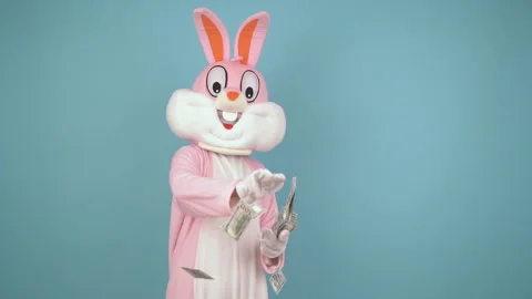 Easter bunny or rabbit or hare holds dollars, throws money from the palm. Easter Vidéo 147971339