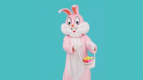 Easter bunny or rabbit or hare with basket of colored eggs, having fun, dancing Stock Footage 148255127