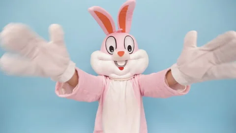 Easter bunny or rabbit or hare with basket of colored eggs, shows thumb finger Видео 148402232