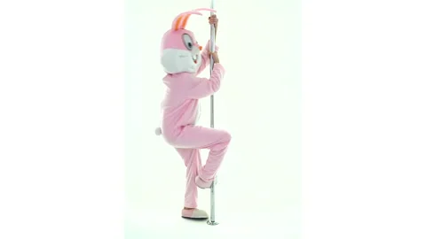 Easter bunny or rabbit or hare is dancing and stripping spinning rotates on pole Video stock 149417494